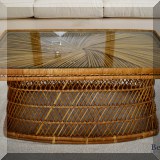 F64. Vintage rattan coffee table with glass top. 